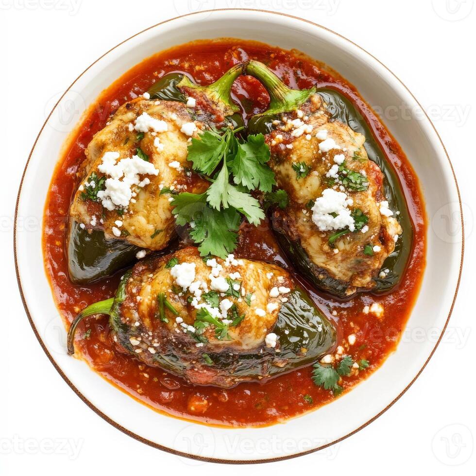 A plate of authentic Mexican chiles rellenos, featuring large poblano peppers stuffed with gooey melted cheese, dipped in a fluffy egg batter, and fried to golden perfection. Served with a rich tomato sauce and garnished with fresh cilantro and crumbled q photo