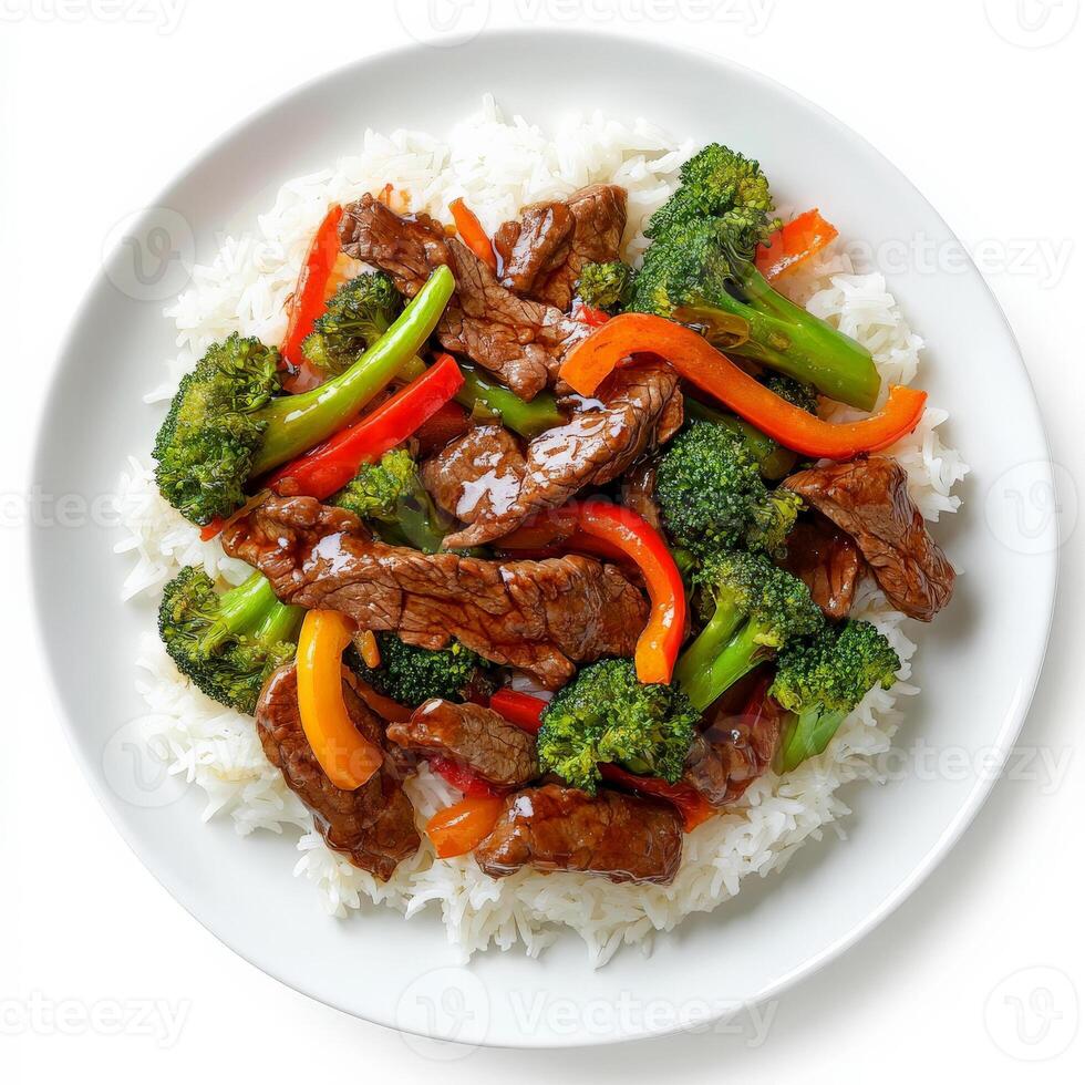 A plate of beef and vegetable stir-fry with tender strips of beef, bell peppers, broccoli, and carrots, tossed in a savory soy and ginger sauce, served over steamed rice. Isolated on clean white background photo
