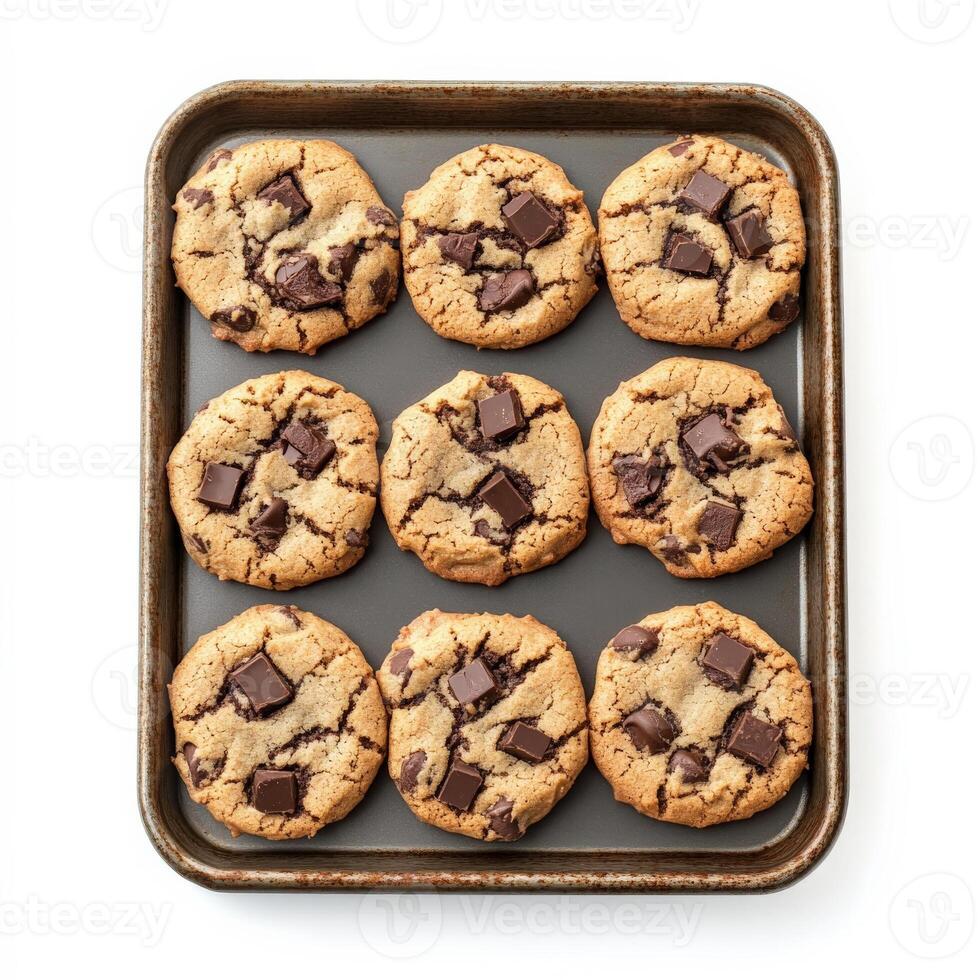 A tray of freshly baked chocolate chip cookies, slightly crisp on the edges with gooey melted chocolate chunks inside. The cookies are arranged in a cozy, homemade style. Isolated on clean white background photo