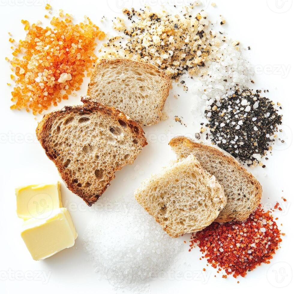 A tasting arrangement of salts from around the world, each with a distinct color and texture, presented with bread and butter, a celebration of the subtle nuances in a fundamental seasoning, isolated on clean white background. photo