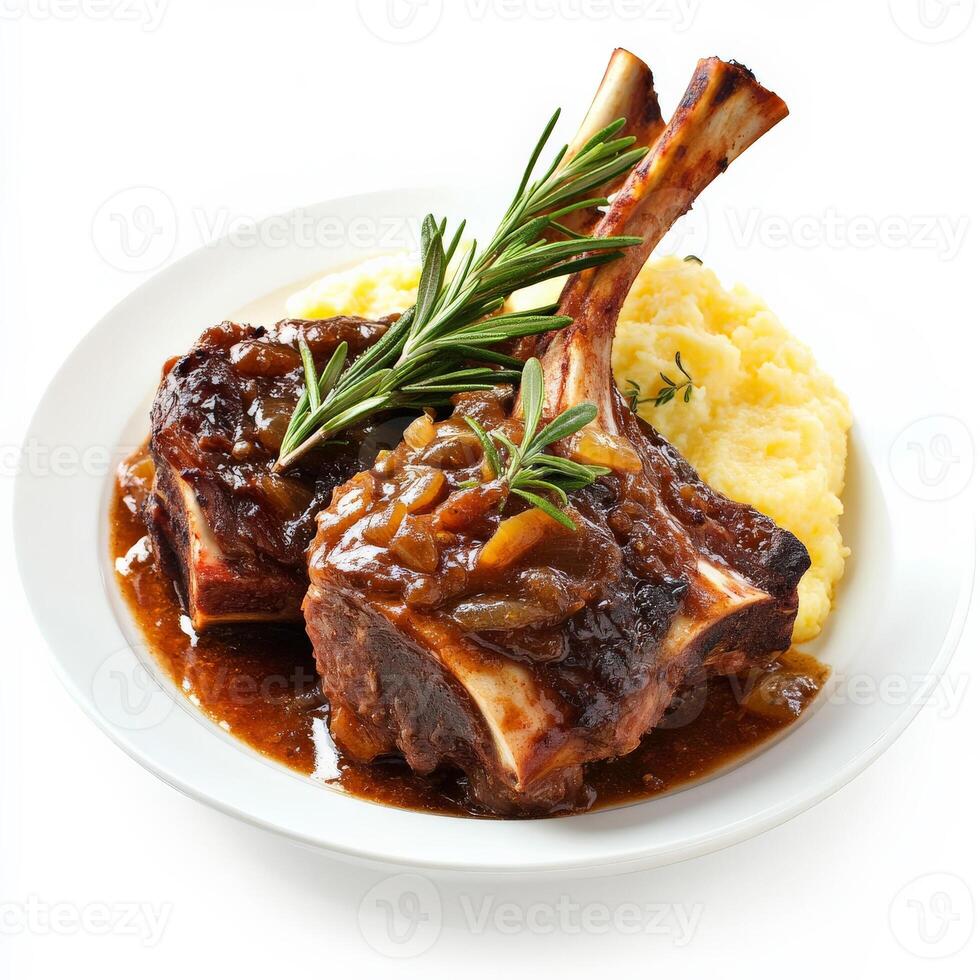 A plate of lamb chops with gravy and mashed potatoes photo