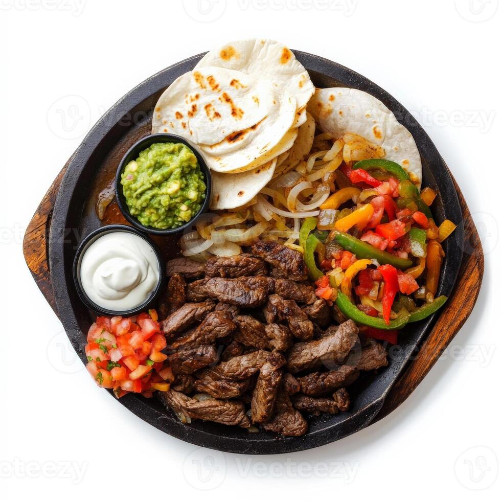 Mexican food with steak, tortillas, peppers, and salsa photo