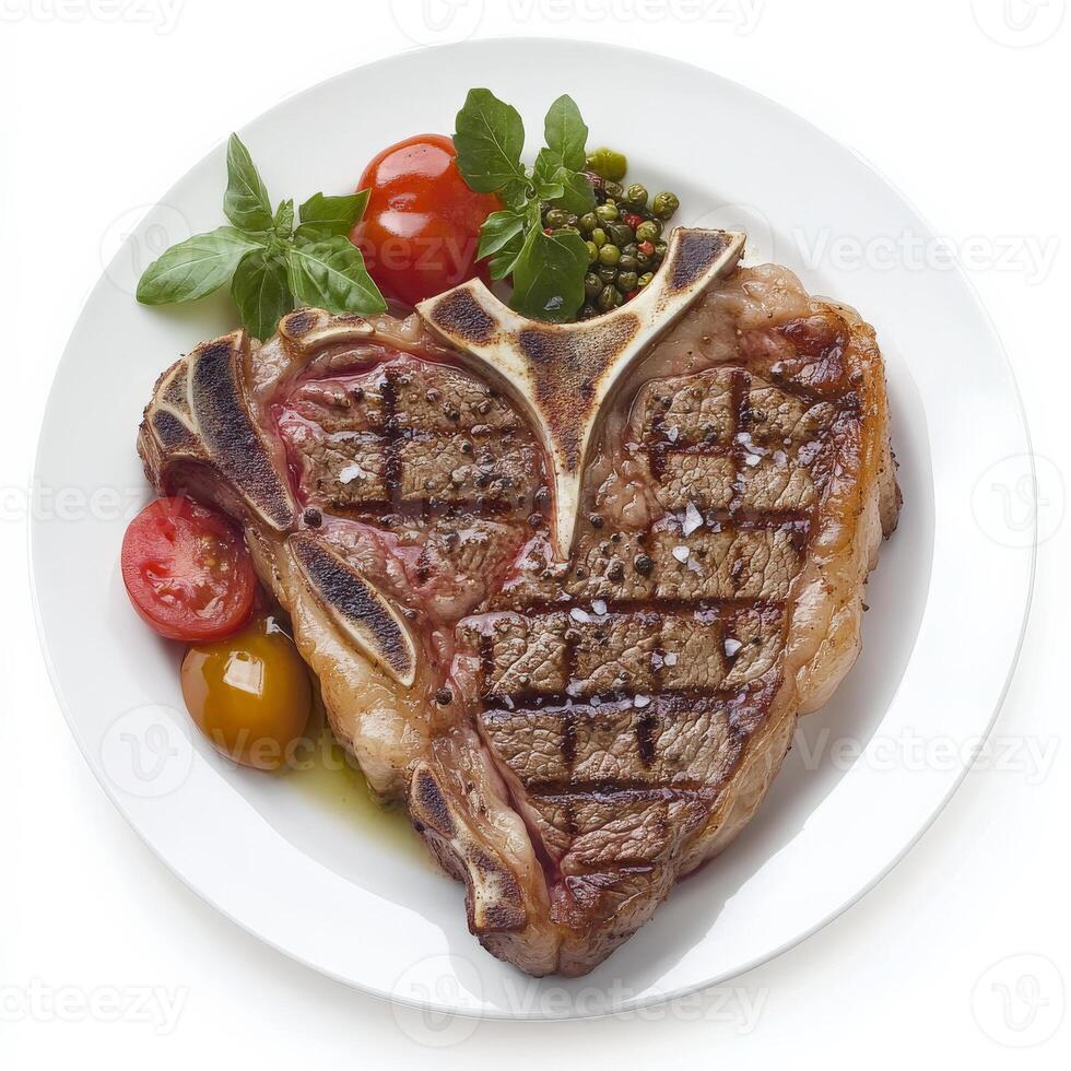 A piece of steak with vegetables and tomatoes on a white plate photo
