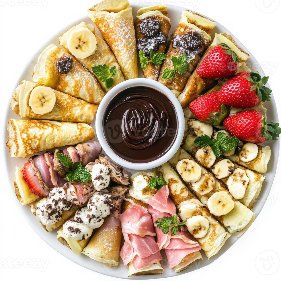 A plate with various types of crepes and fruit photo