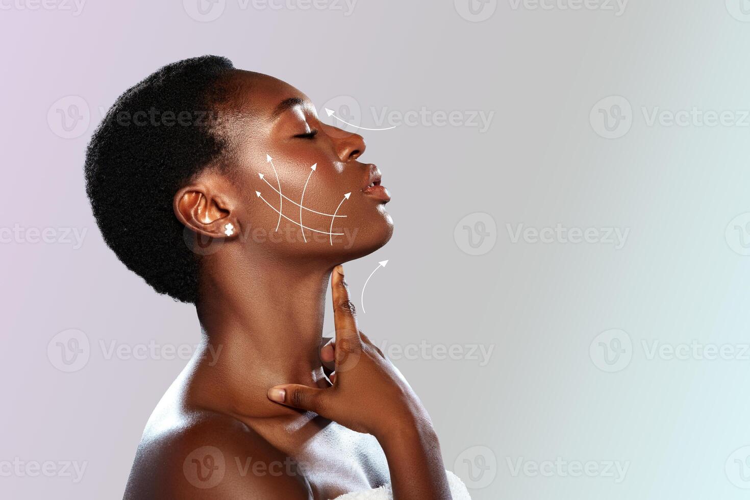 Woman showcasing skincare techniques for facial rejuvenation in a serene studio setting during daylight photo