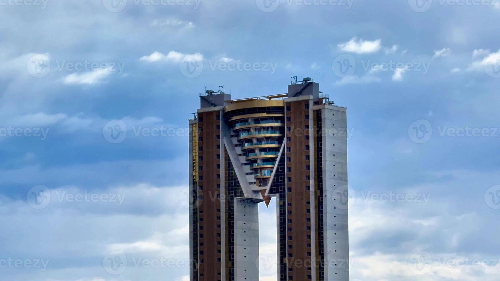 A striking and visually captivating building design featuring an innovative and unique shape set under a dramatic sky photo