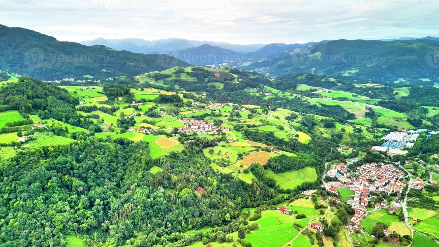This beautiful aerial shot captures the vibrant green fields and serene rolling hills of the picturesque countryside photo