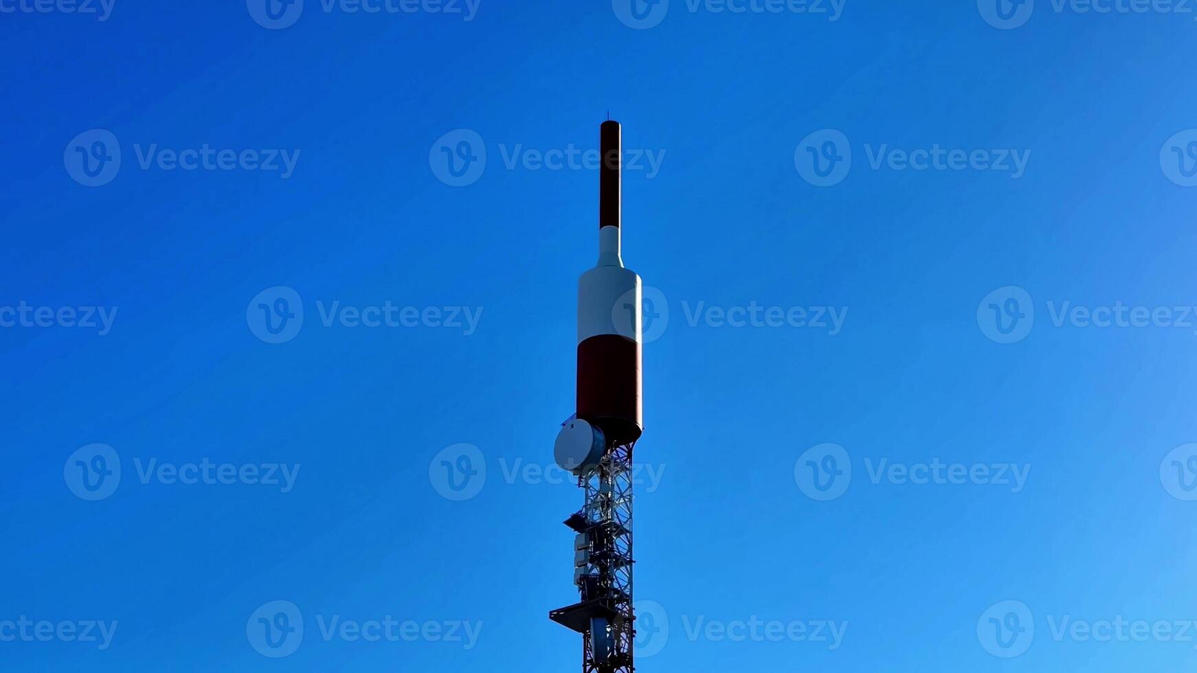 A cell tower with a large antenna on top photo
