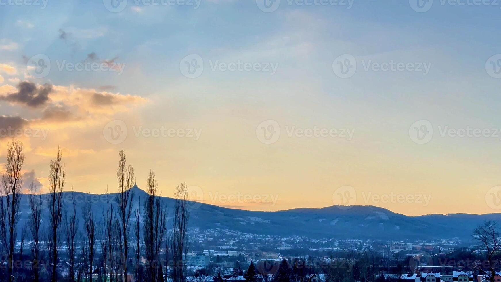 A breathtaking winter sunrise casts a warm glow over the majestic mountains and vibrant morning sky photo