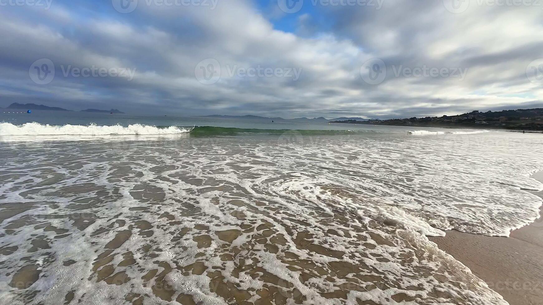 A tranquil beach scene with soft waves and a dramatic evening sky, ideal for relaxation and unwinding photo