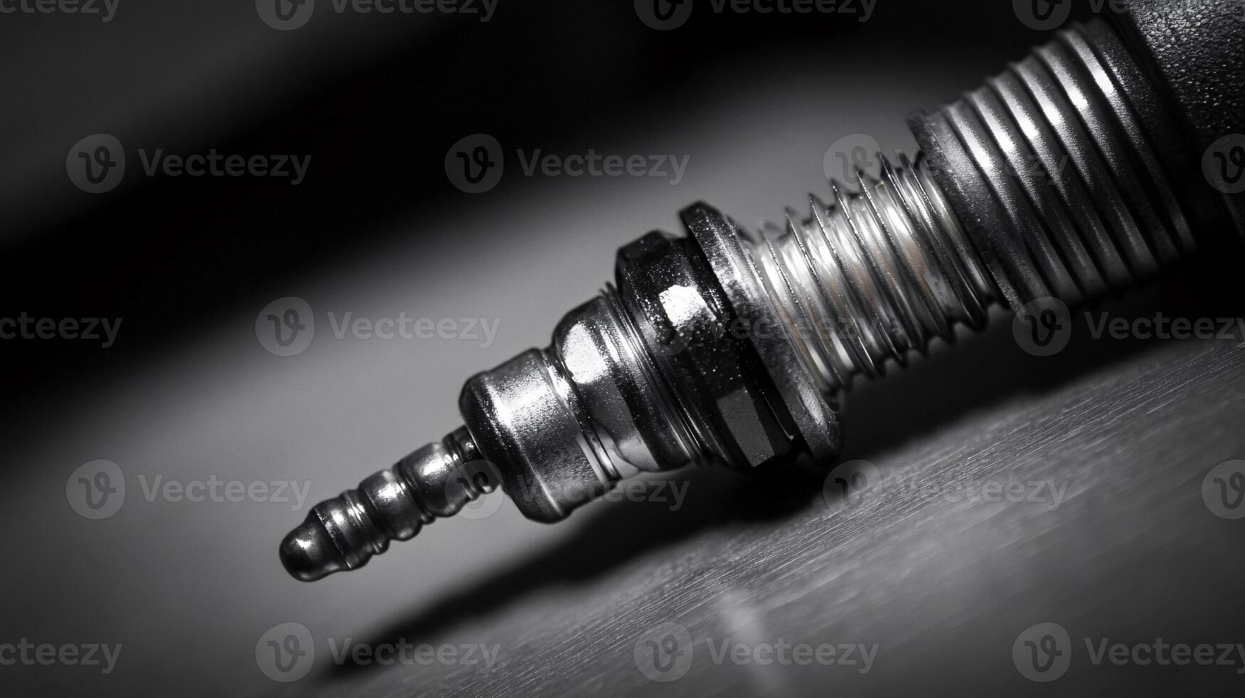 Extreme Close-up of a Spark Plug Being Removed from Engine Block photo