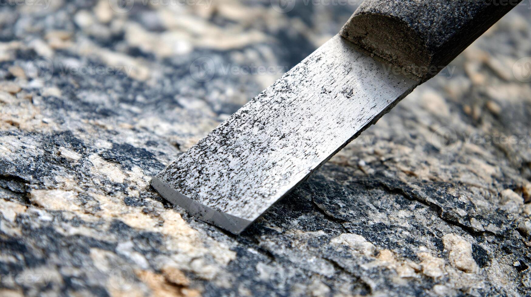 Skilled Artisan Shaping Raw Granite with a Precision Stone Chisel photo