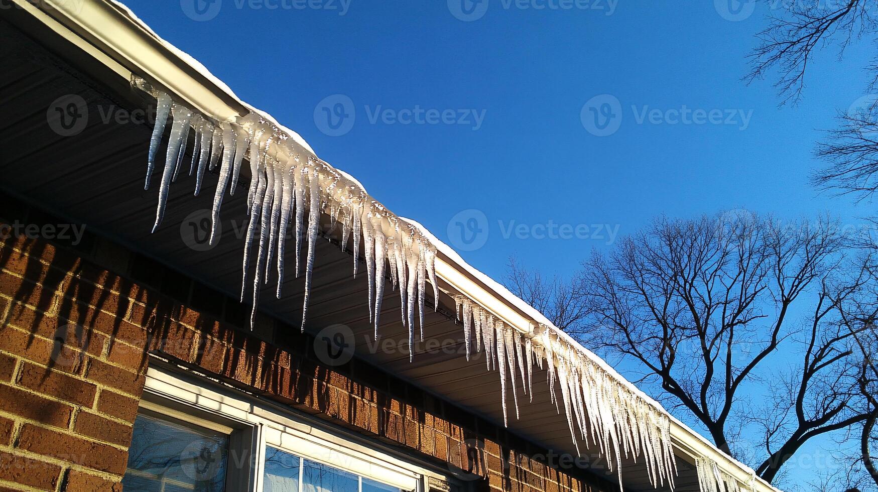 Glistening Icicles Dangle from Rooftops Under Winter Sunlight photo