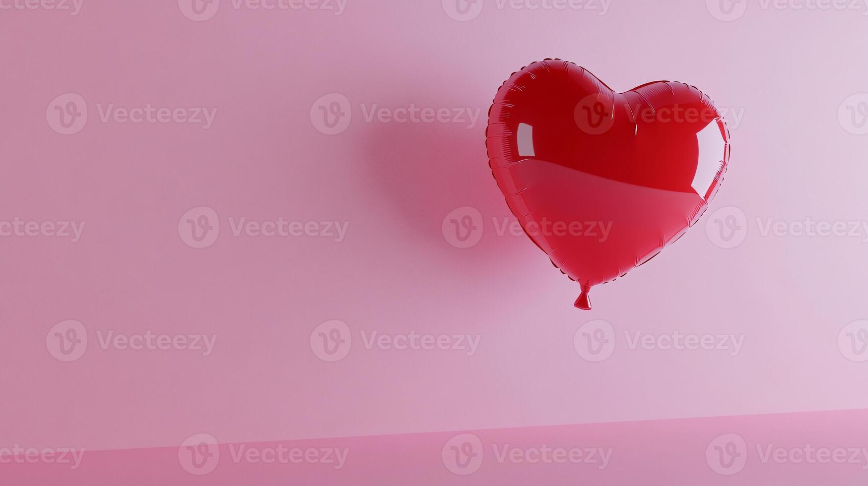 Red heart-shaped balloon gracefully floating on a soft pink background photo