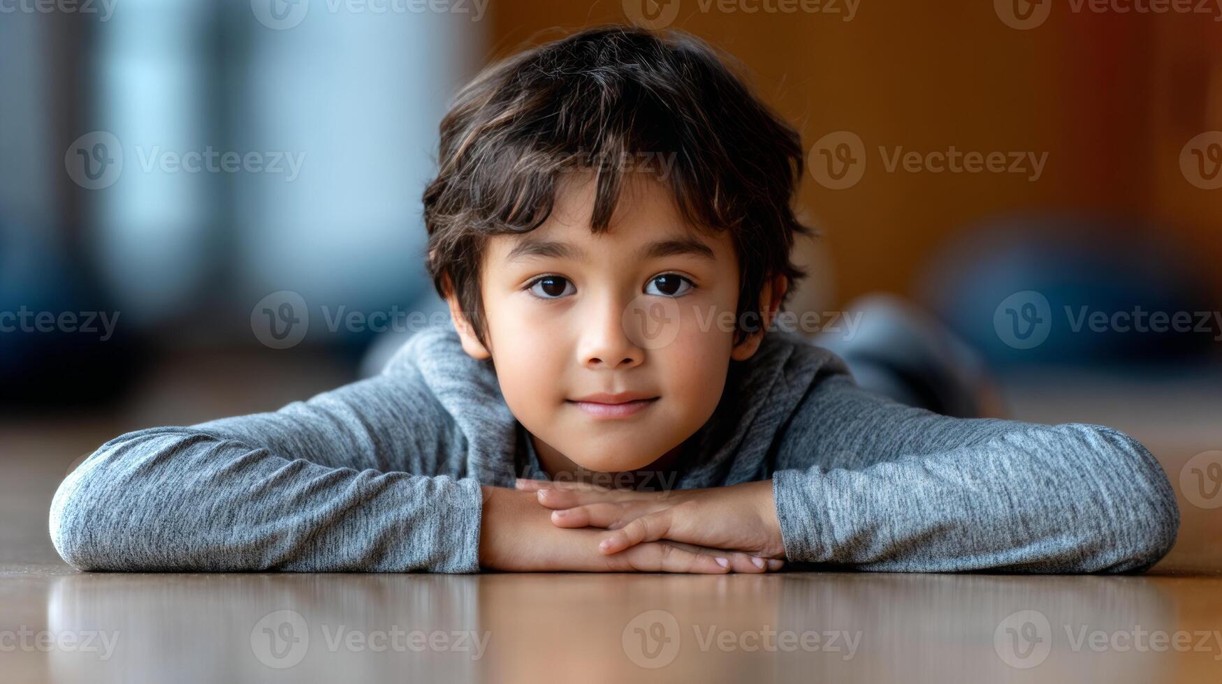 A Latino boy is engaged in yoga, performing the pigeon pose with his arms stretched out, showing focus and determination in a serene indoor environment. photo