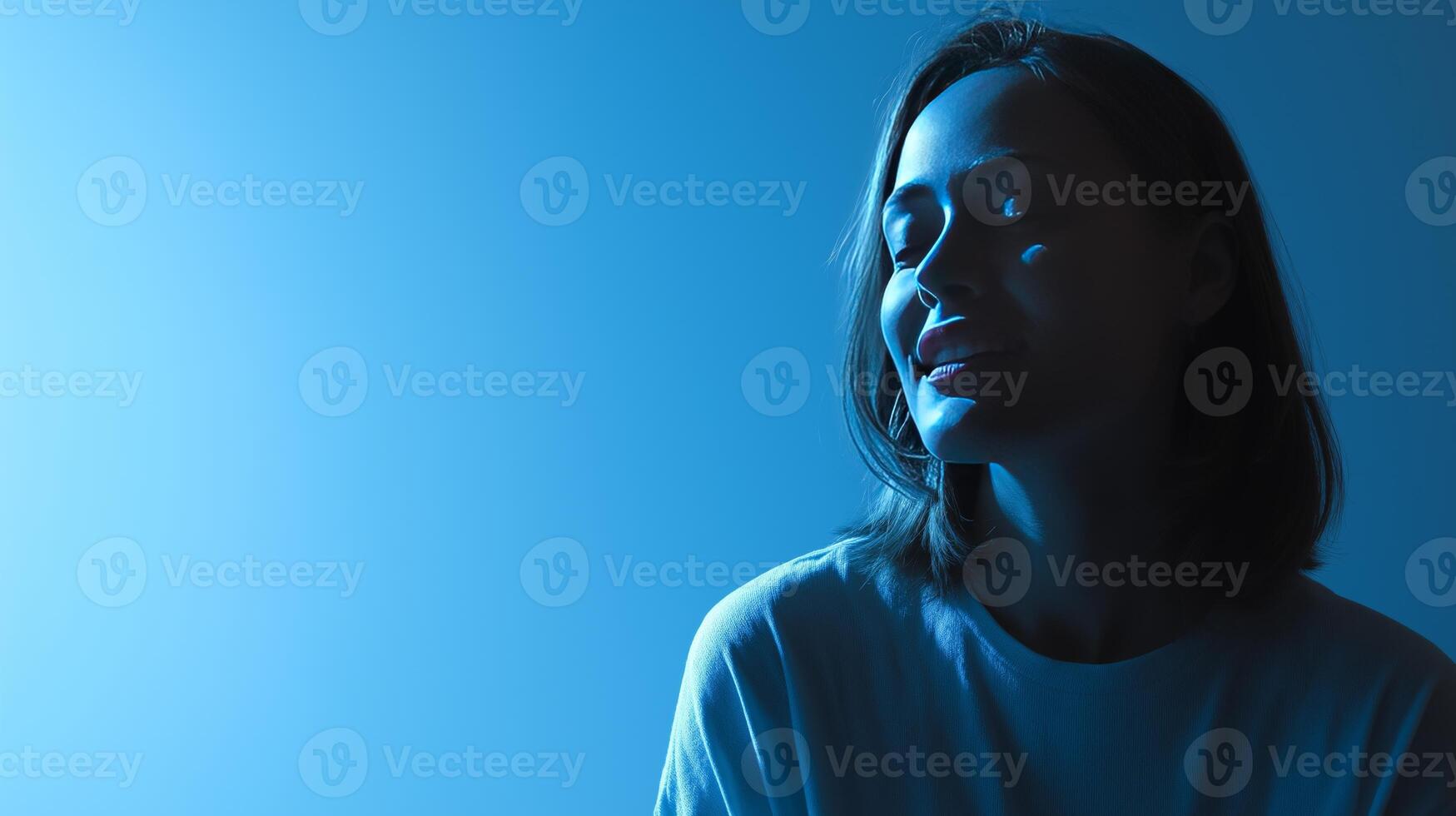 A person with medium-length hair smiles in a softly lit environment, engaged in a thoughtful discussion about artificial intelligence. The ambiance is calming and introspective. photo