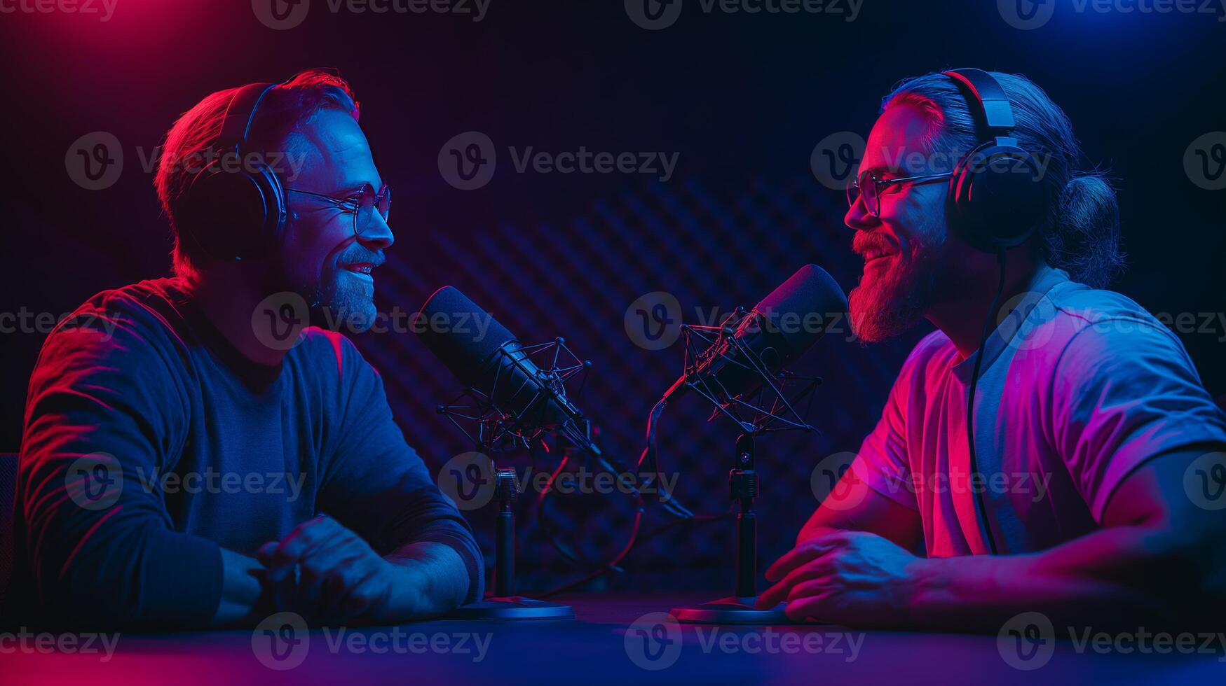 Two hosts share an insightful conversation about AI and the future of technology in a vibrant podcast studio. The colorful lighting creates a dynamic atmosphere as they engage with each other. photo