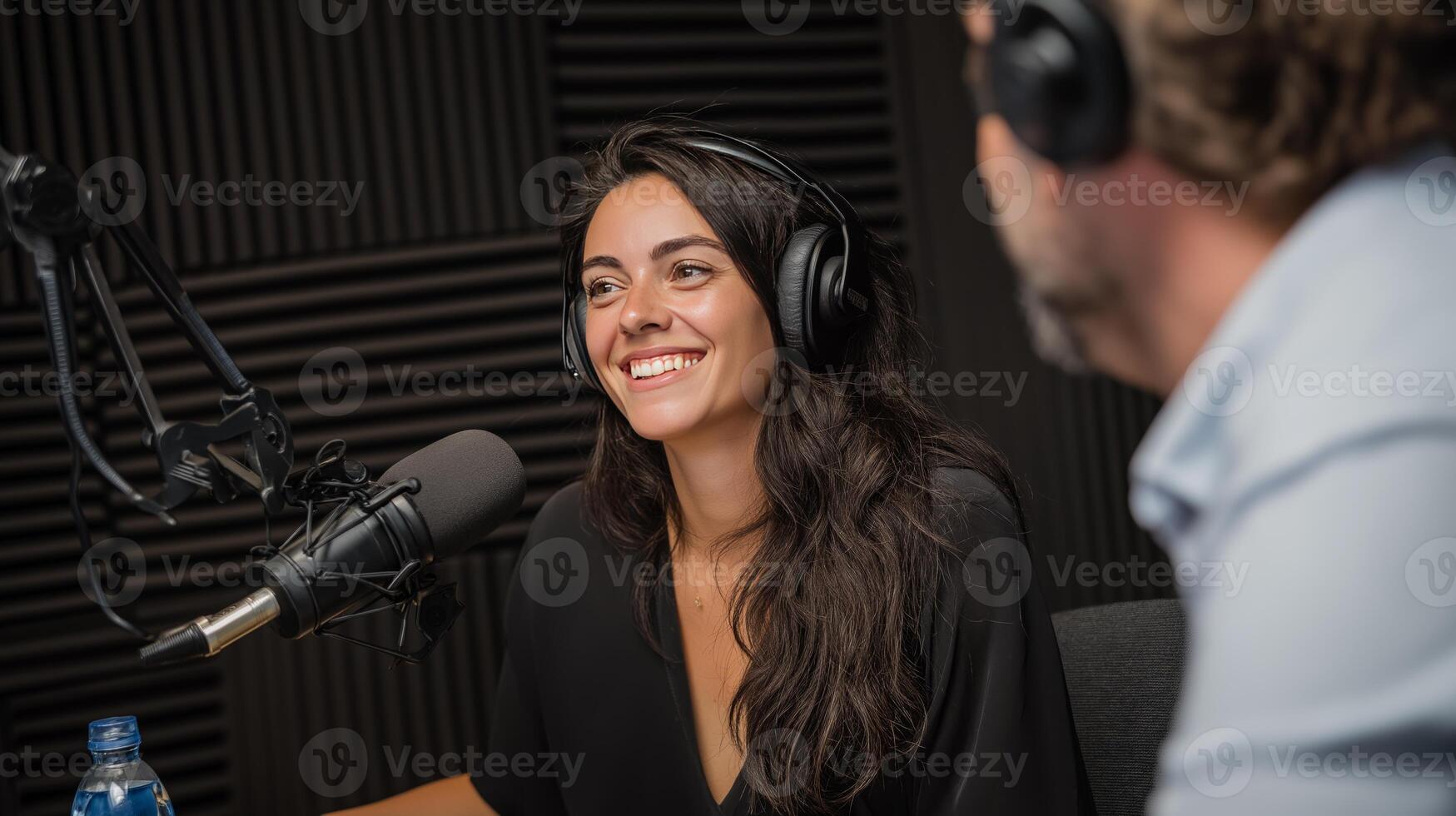 Two individuals engage in a lively conversation about artificial intelligence in a professional podcast studio. The atmosphere is bright with excitement as ideas flow freely. photo