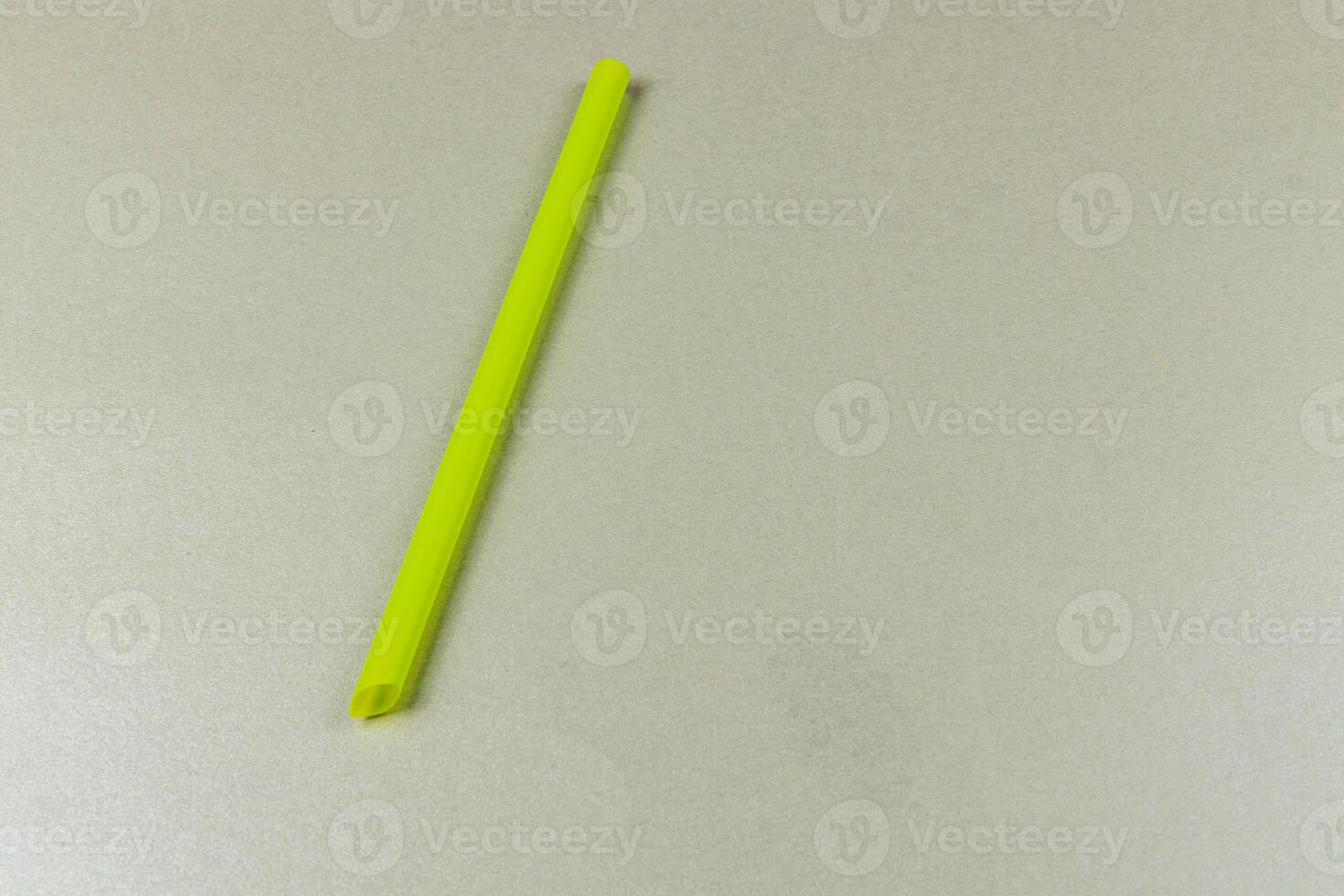 Bright yellow straw placed on a light surface in a kitchen photo