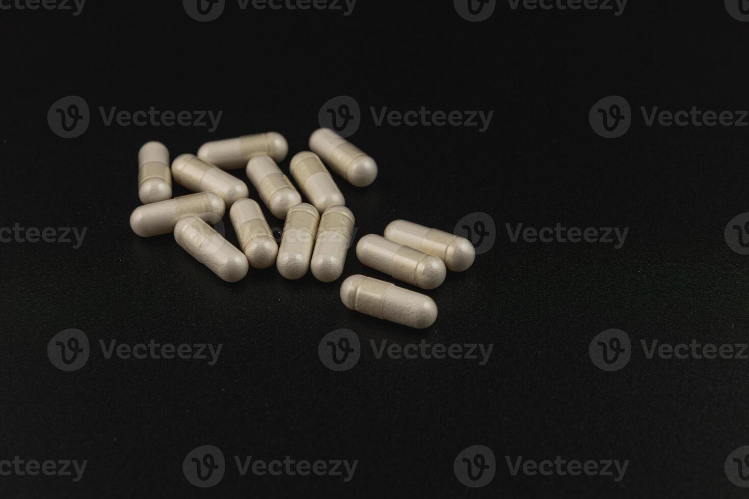 Natural health supplements arranged on a dark surface photo