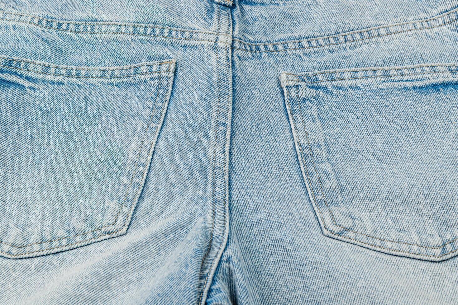 Popular light blue denim jeans showcasing back pockets photo