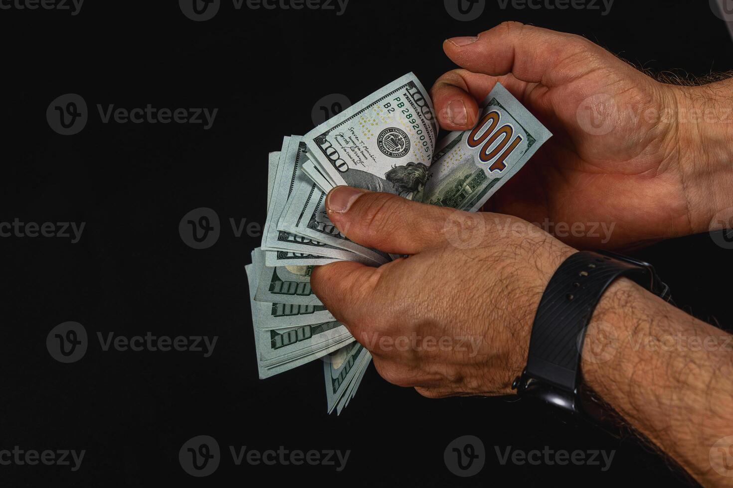 Counting cash in hands with dark background and focus photo