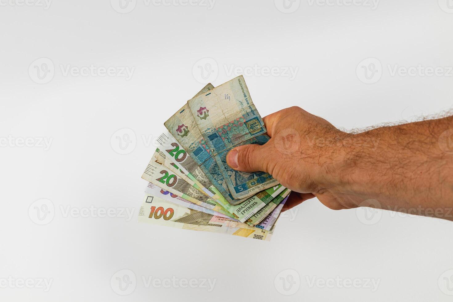 Hand holding various denominations of cash banknotes photo