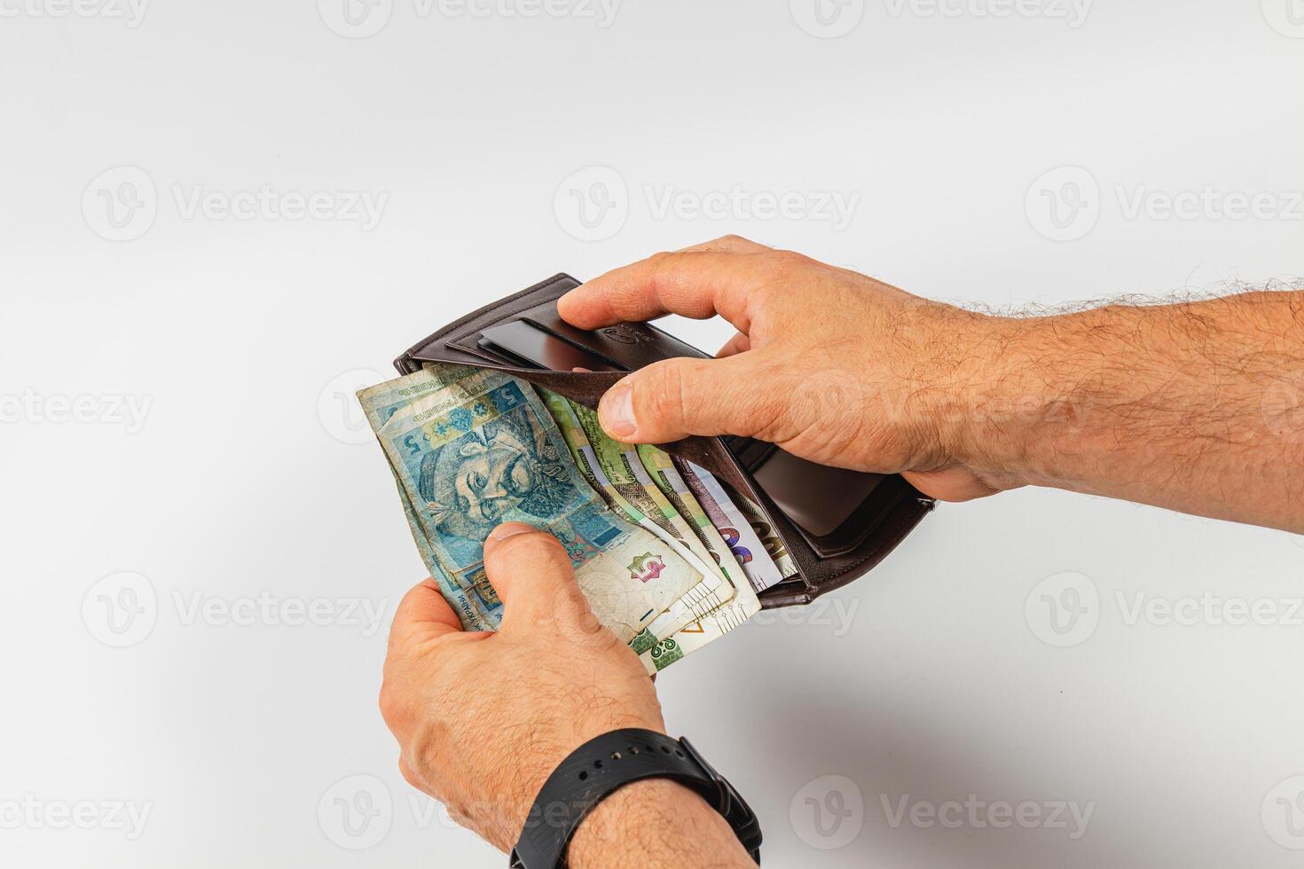 Holding a wallet with cash inside in a neutral setting photo
