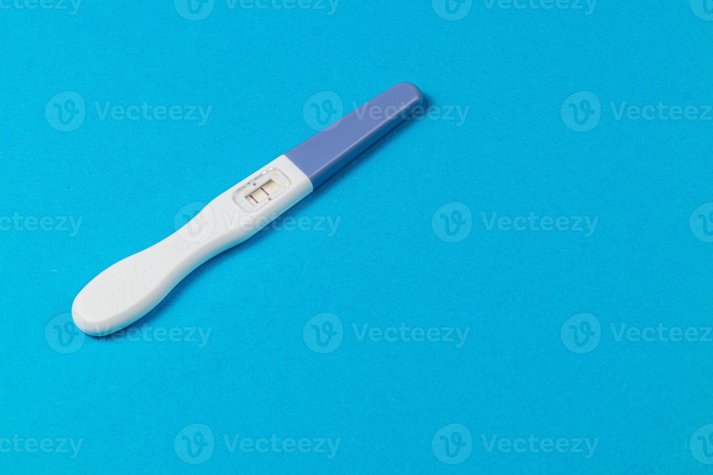 Pregnancy test on a blue background ready for results photo
