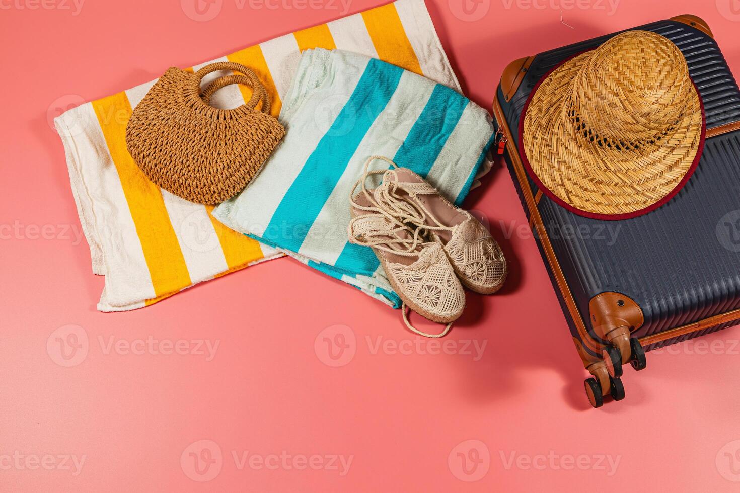 Packing for a beach vacation with essentials on colorful backdrop photo