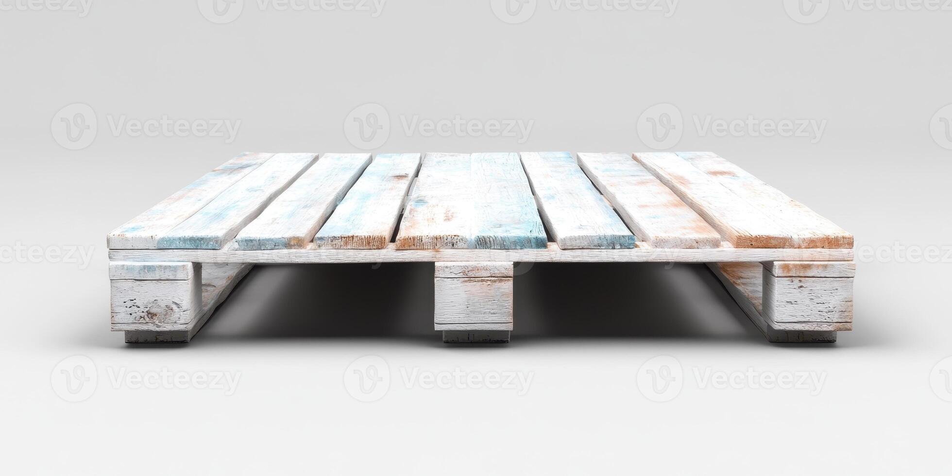 Wooden pallet resting on a smooth surface showcasing fading paint and weathered texture in a minimalistic indoor setting photo