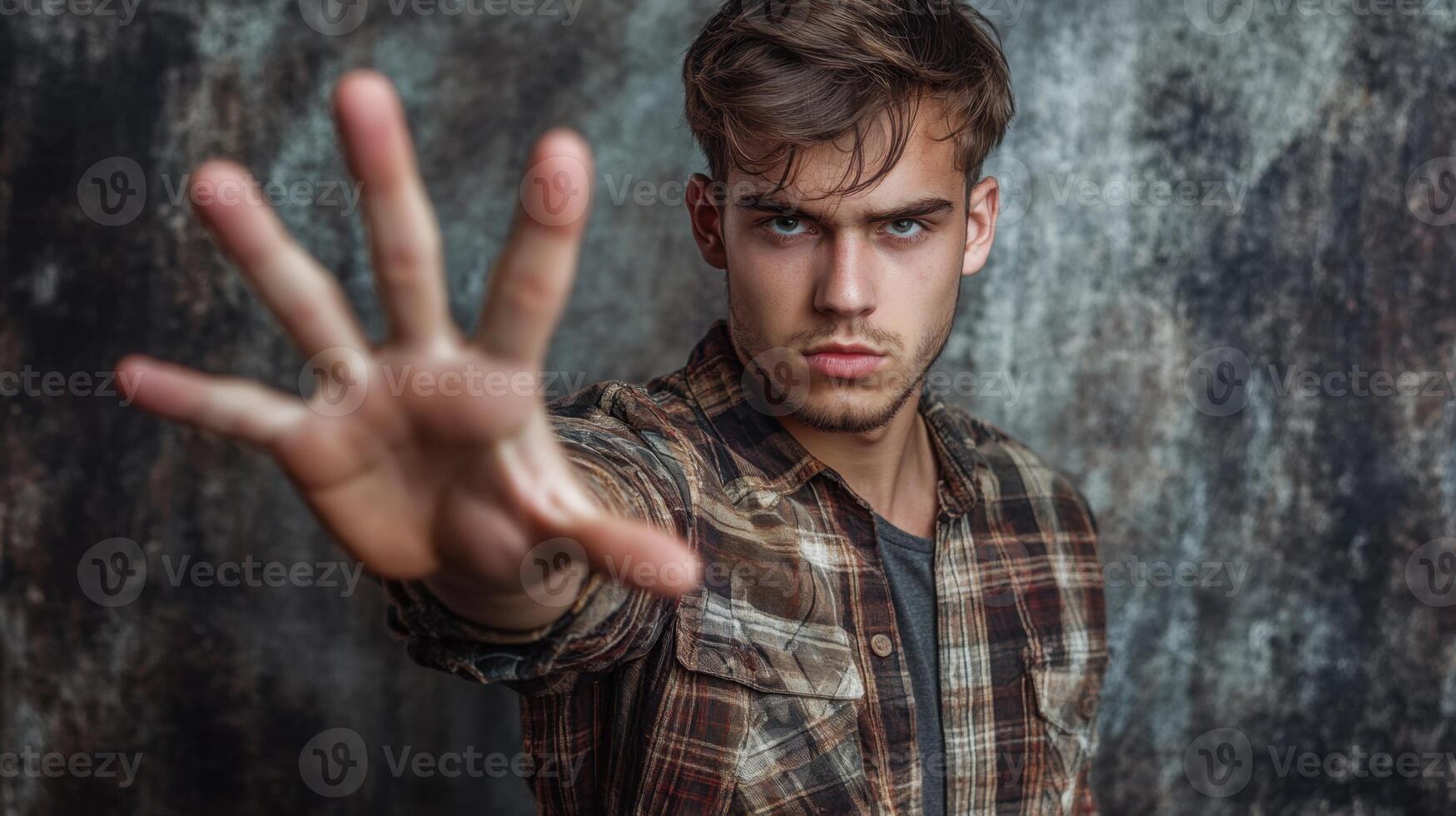 a man is making a stop sign with his hand photo