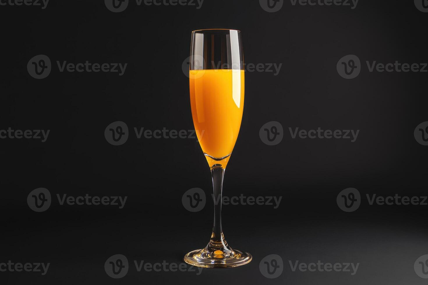orange juice in a glass on a black background photo