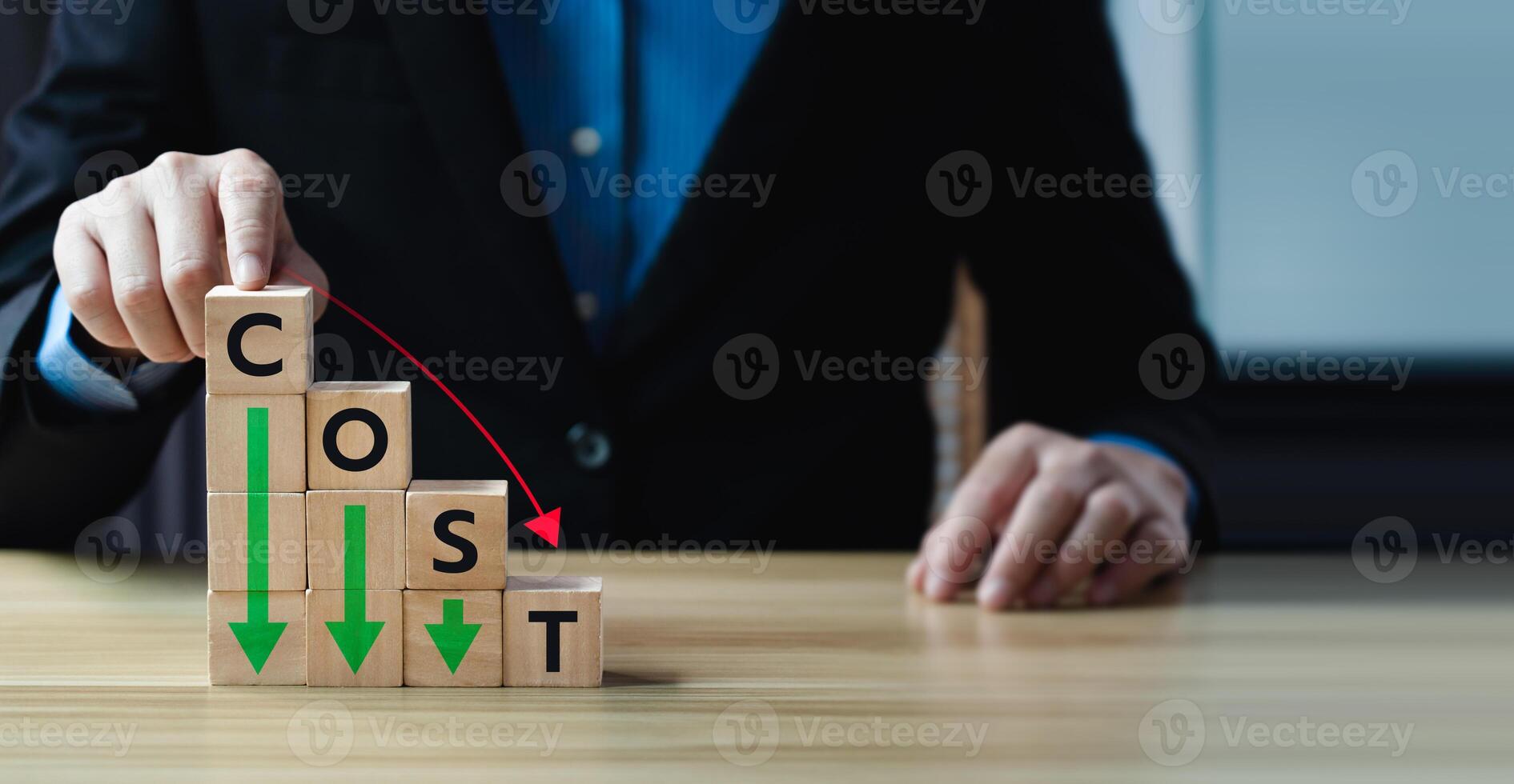 Business concept of cost reduction with stacked wooden blocks forming the word COST, descending arrow, representing expense control, financial optimization, strategic budgeting in corporate planning photo