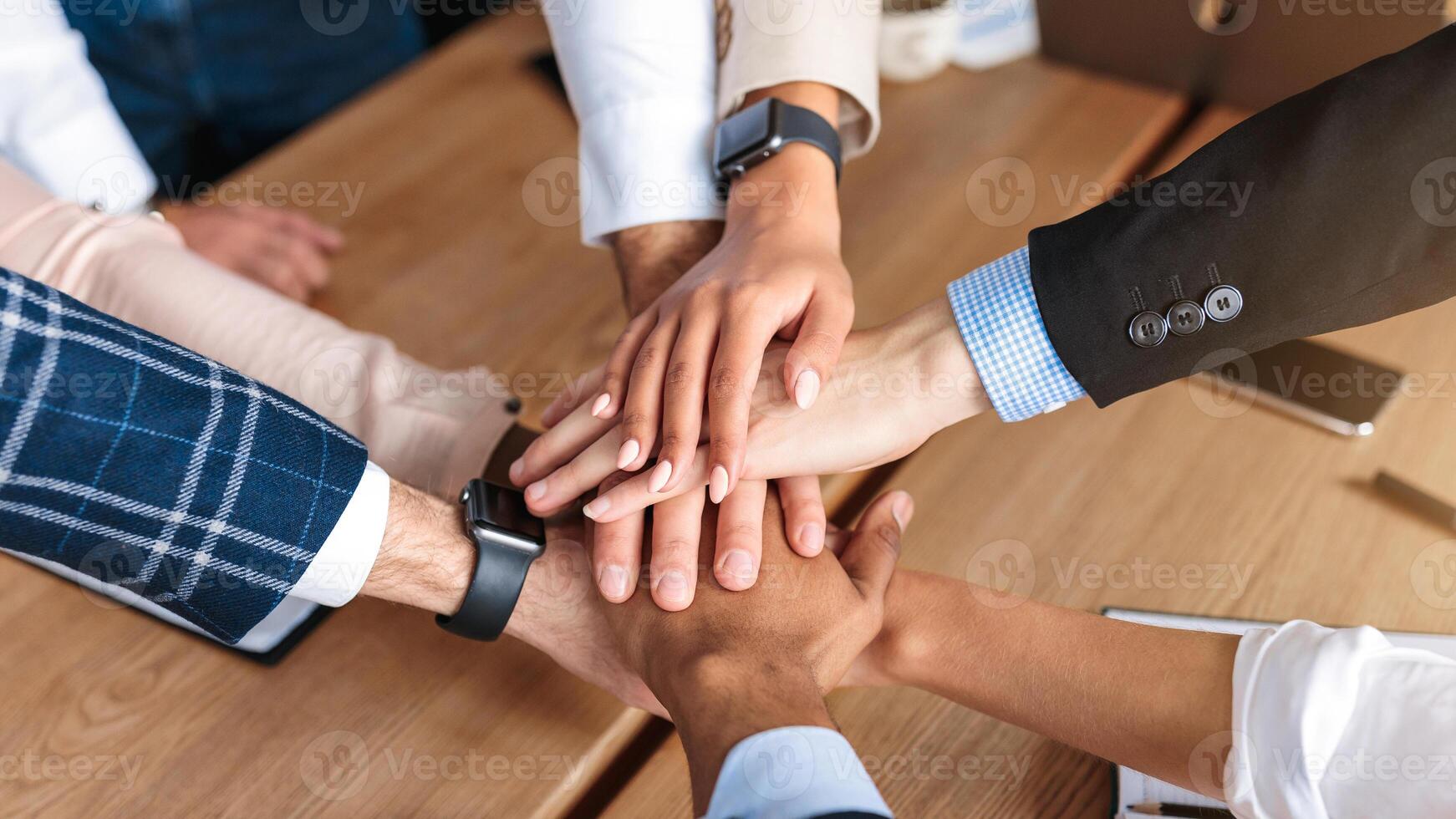 Teamwork. Top View Of United Business Team Holding Hands During Teambuilding Event Standing In Circle In Modern Office. High Angle View Shot. Selective Focus photo