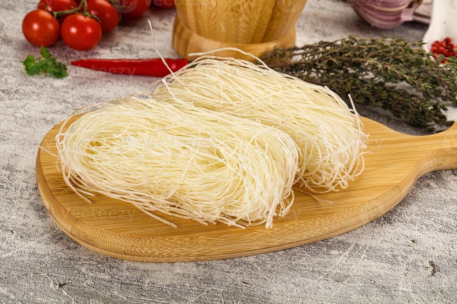 Two pieces of noodles on a wooden cutting board photo