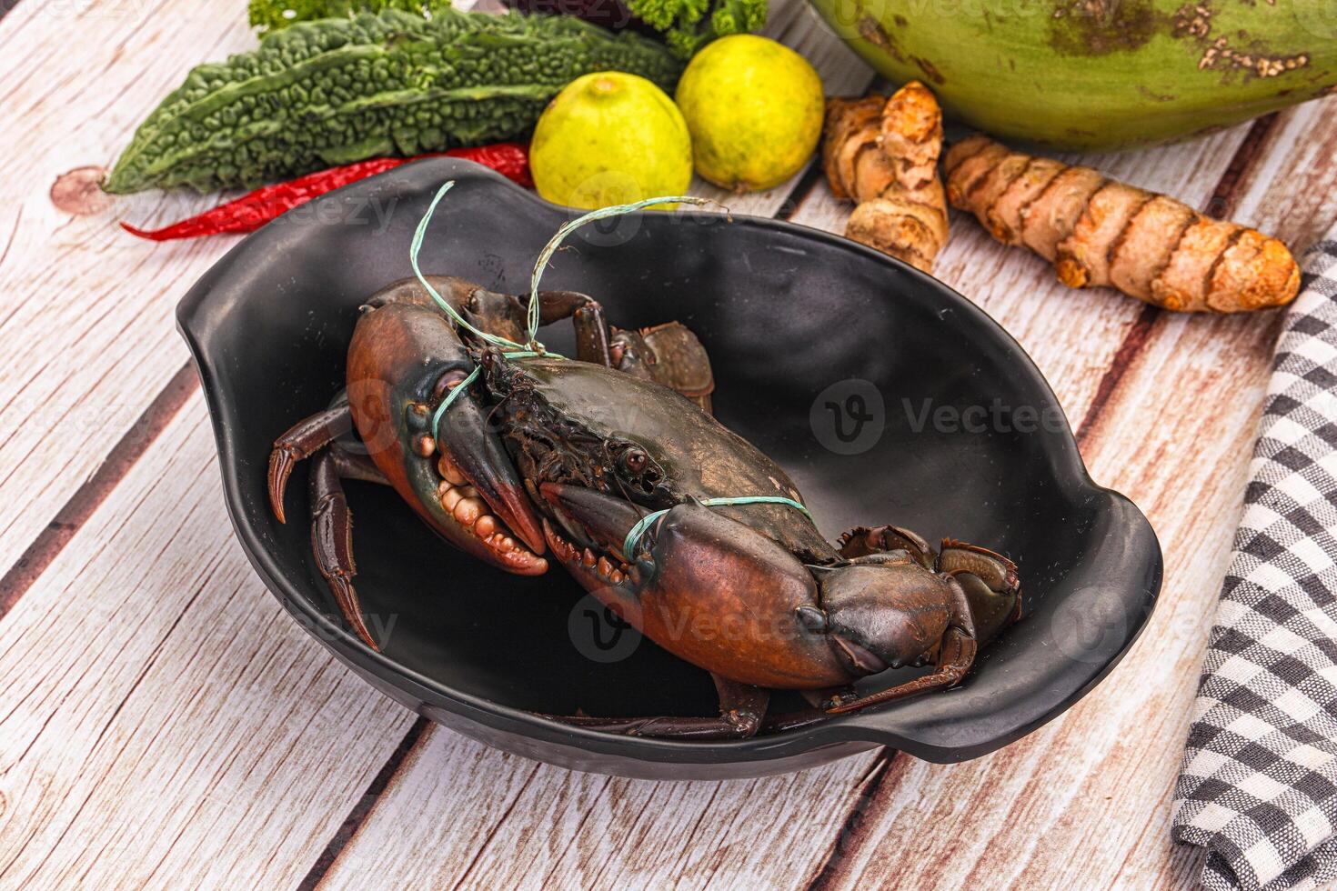 A black bowl with a lobster in it photo