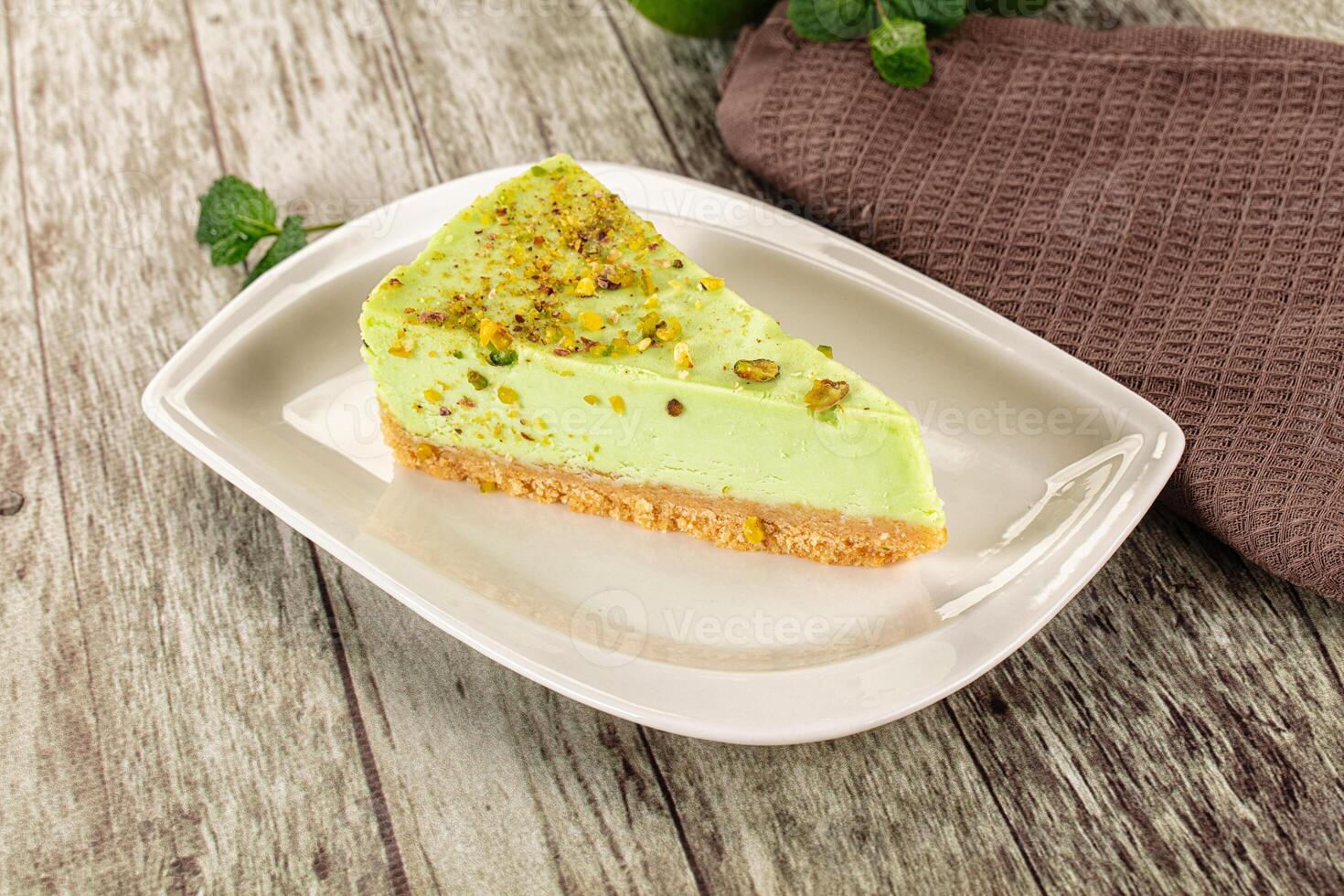 A slice of cake on a plate with a napkin photo