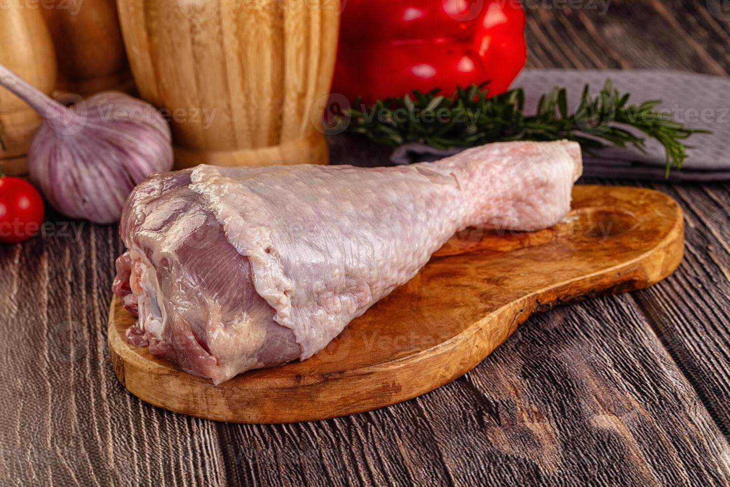 Raw meat on a wooden cutting board with vegetables and spices photo