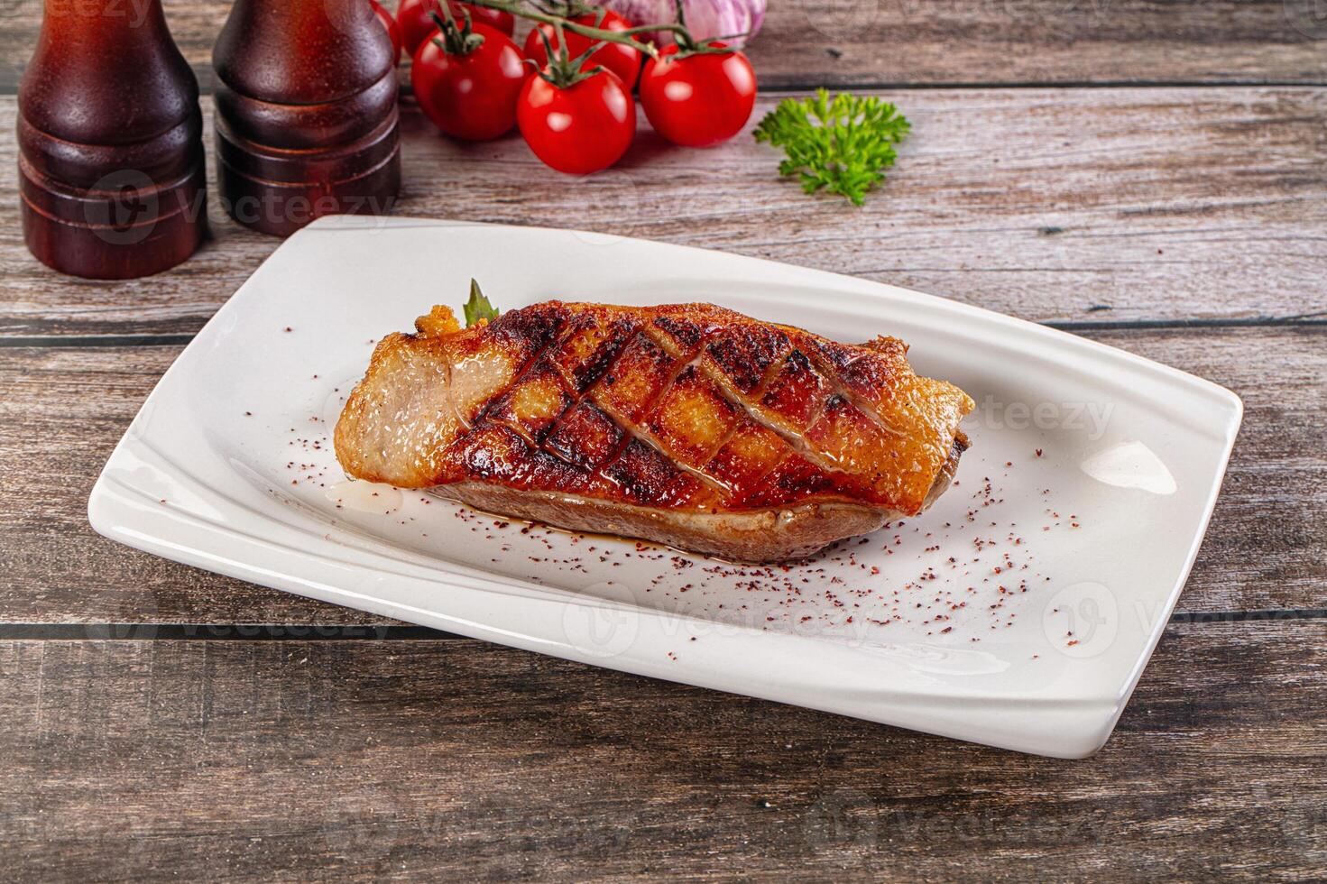 A plate of food on a table with a bottle of ketchup and a bottle of tomato sauce photo