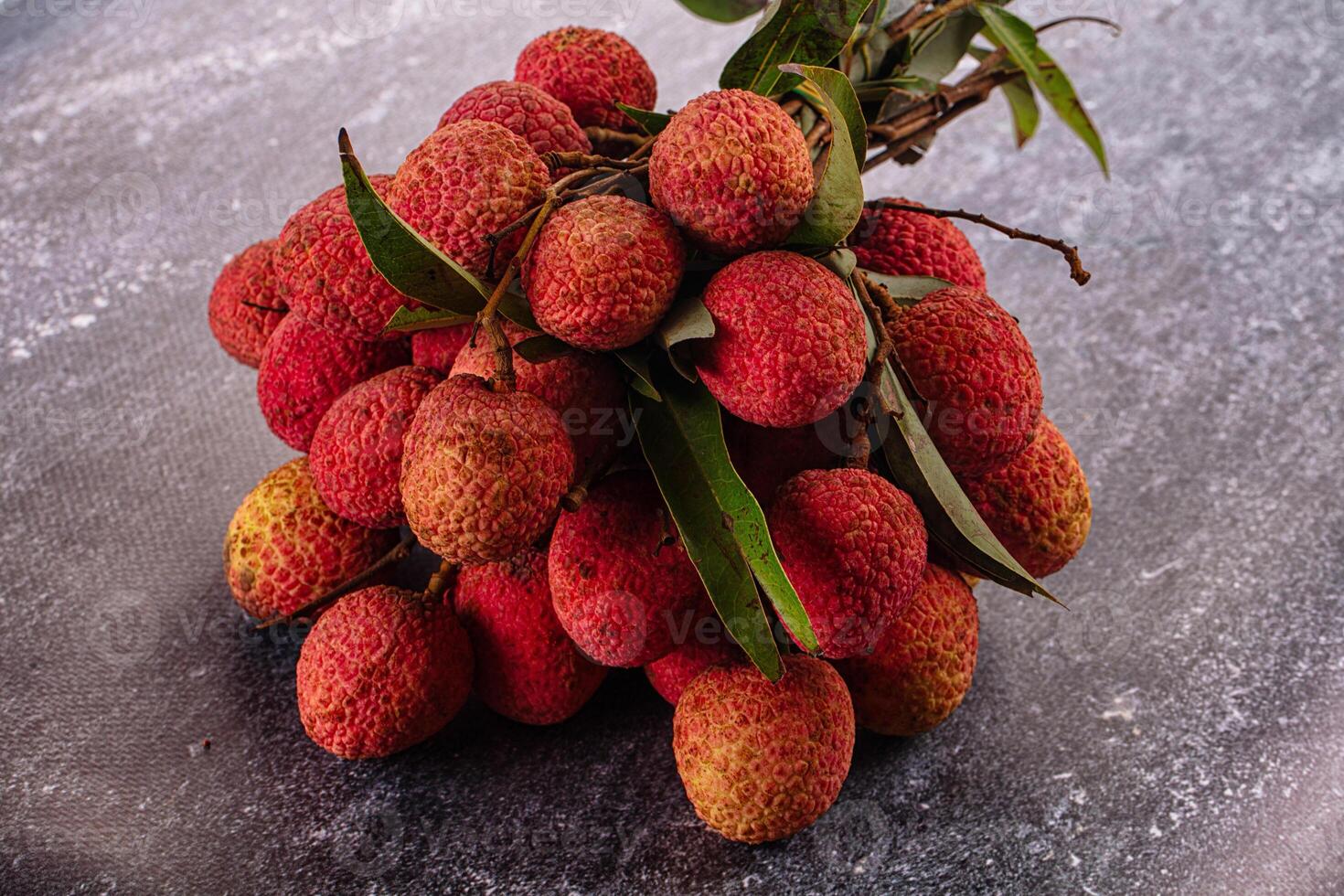 A bunch of litchis on a table photo
