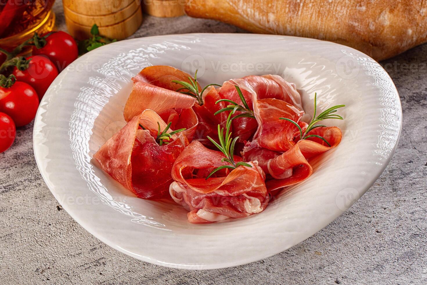 A white bowl filled with sliced meat and vegetables photo
