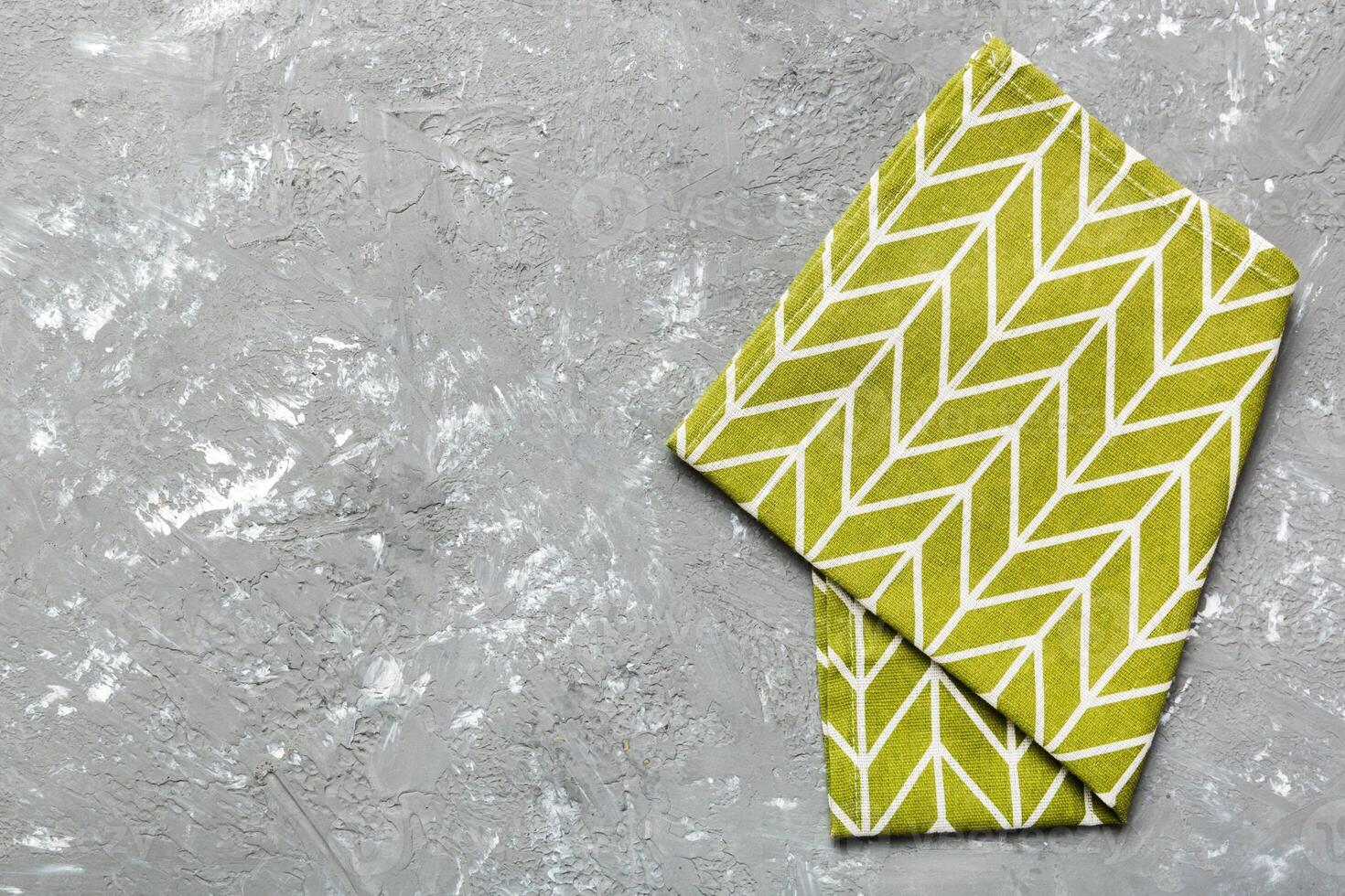 top view with green kitchen napkin isolated on table background. Folded cloth photo