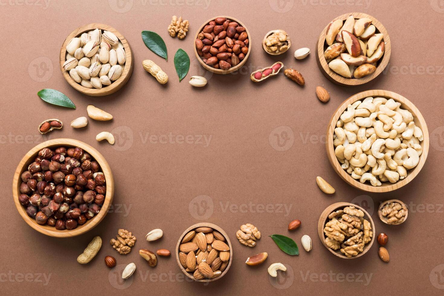 mixed nuts wooden bowl. Mix various nuts on colored background. pistachios, hazelnuts, peanuts and brazil nuts photo