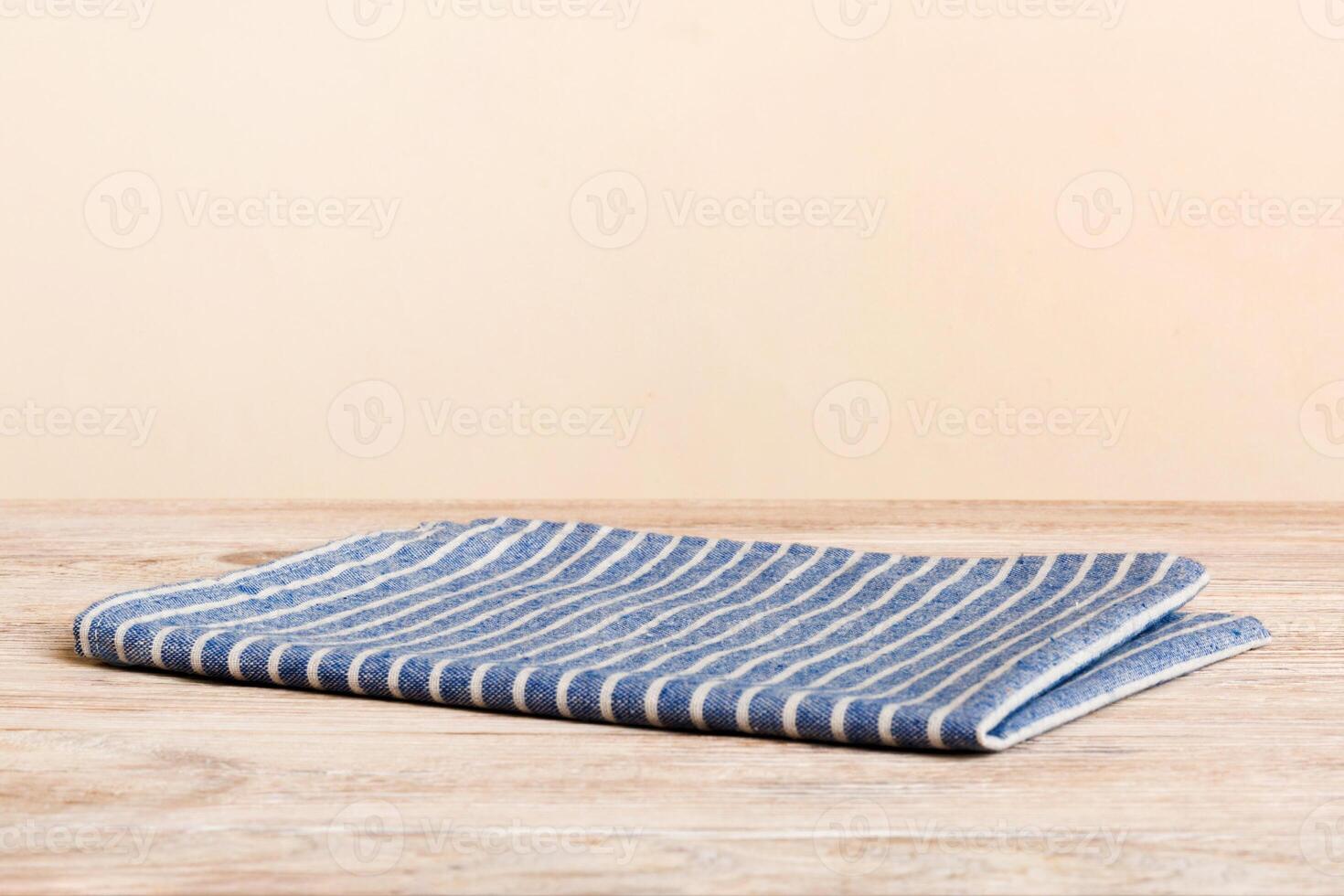 top view with blue kitchen napkin isolated on table. Folded cloth photo