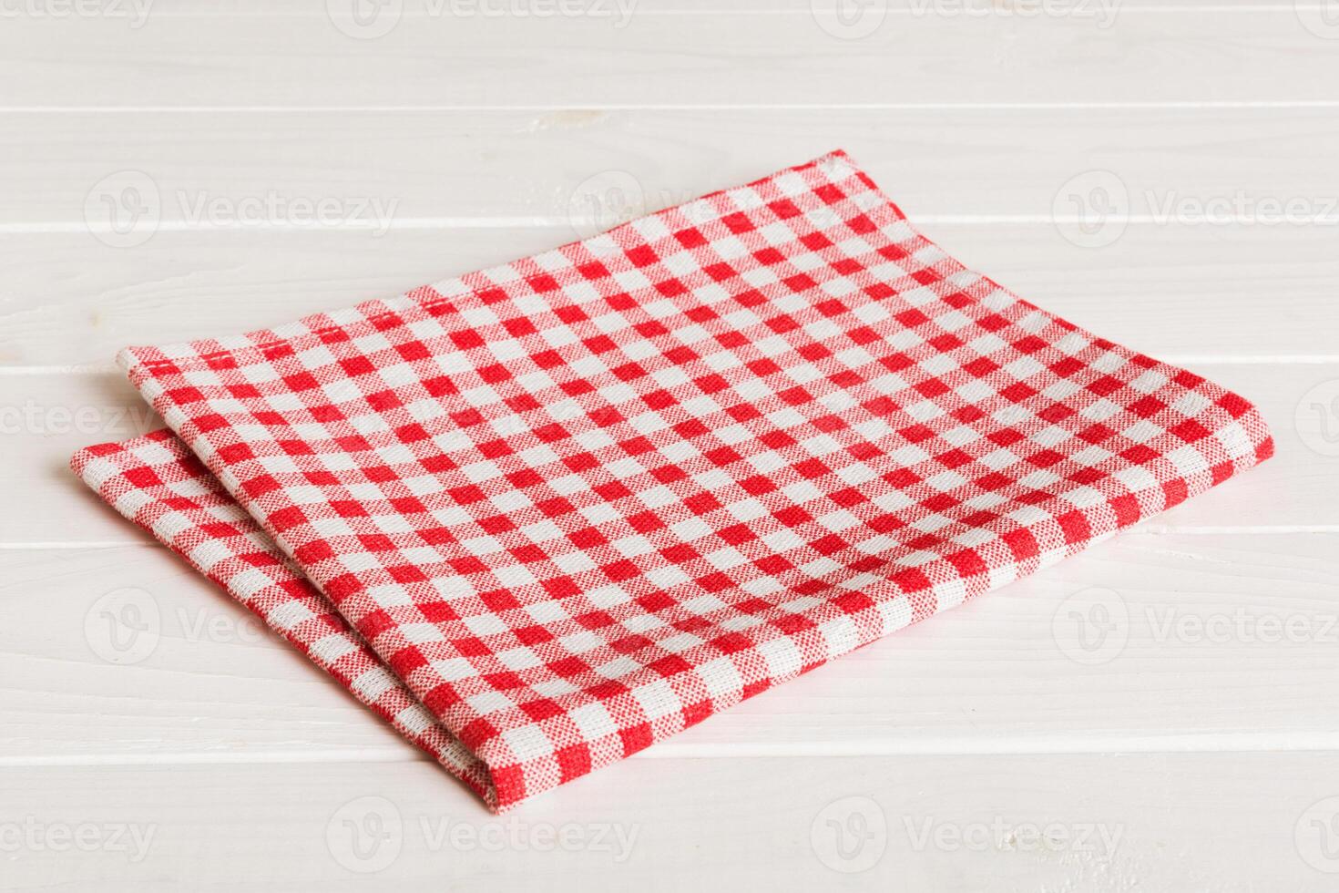 top view red empty kitchen napkin isolated on table . Folded cloth photo