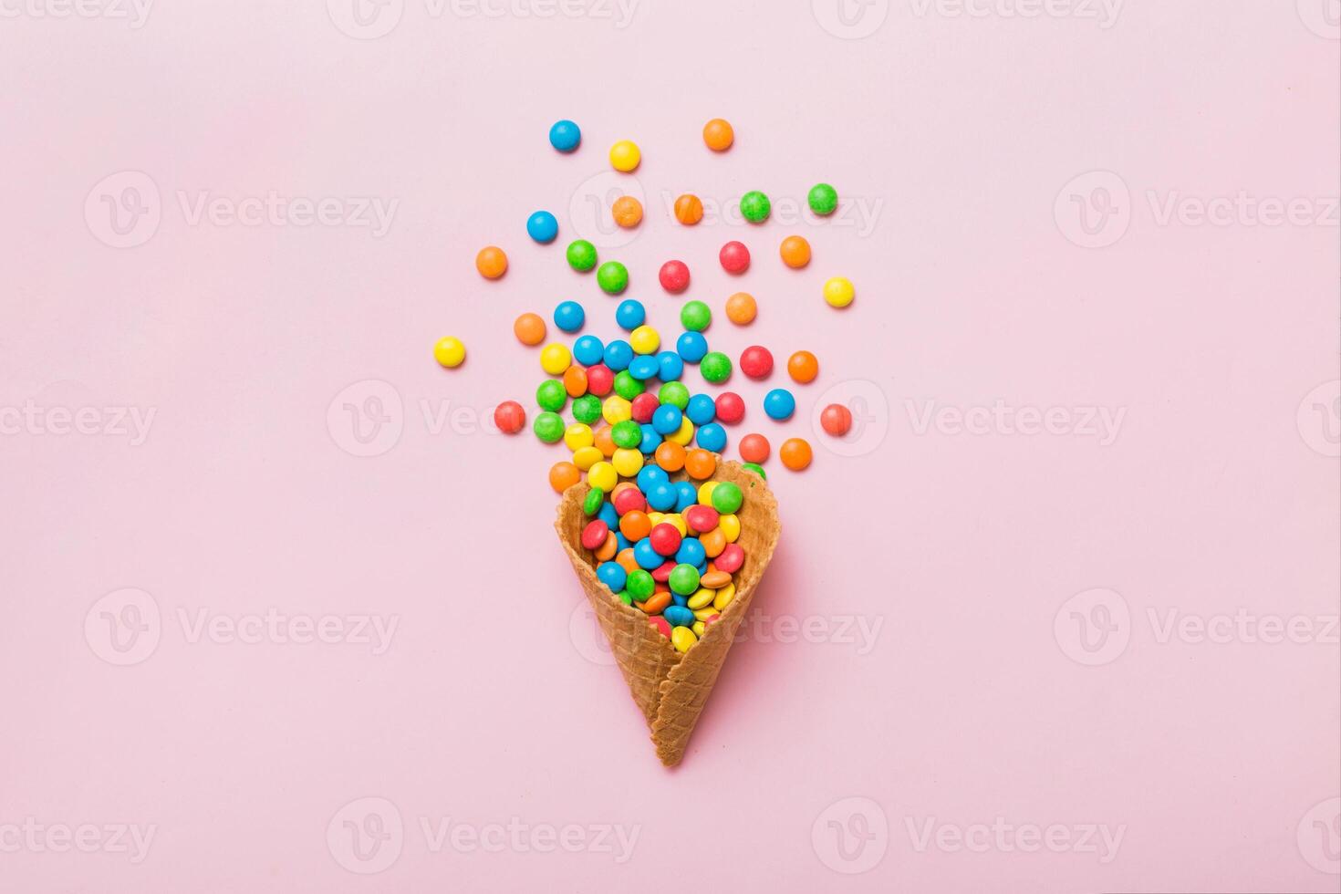waffle full assorted traditional candies falling out on colored background with copy space. Happy Holidays photo