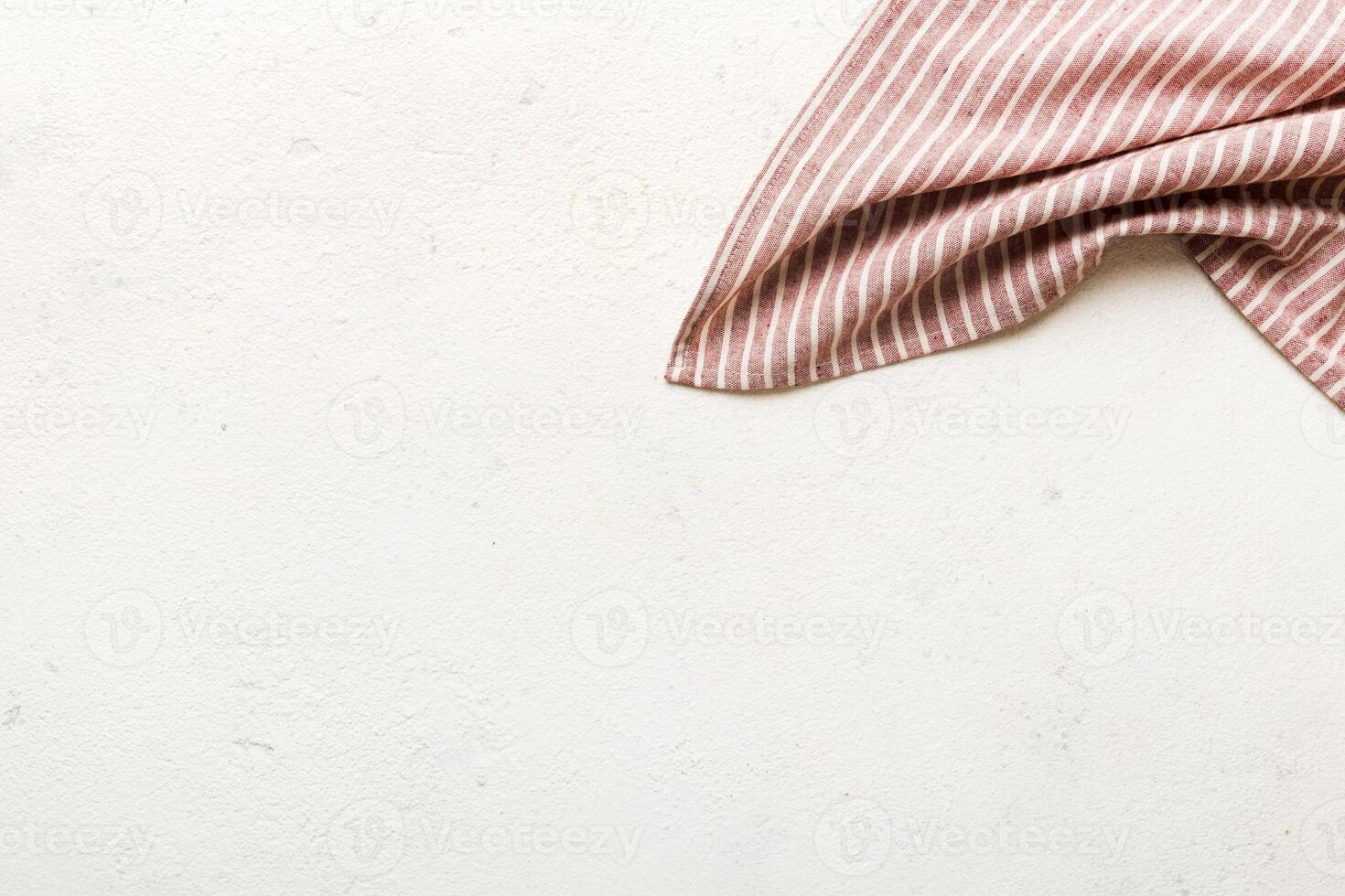top view with red empty kitchen napkin isolated on table. Folded cloth for mockup photo