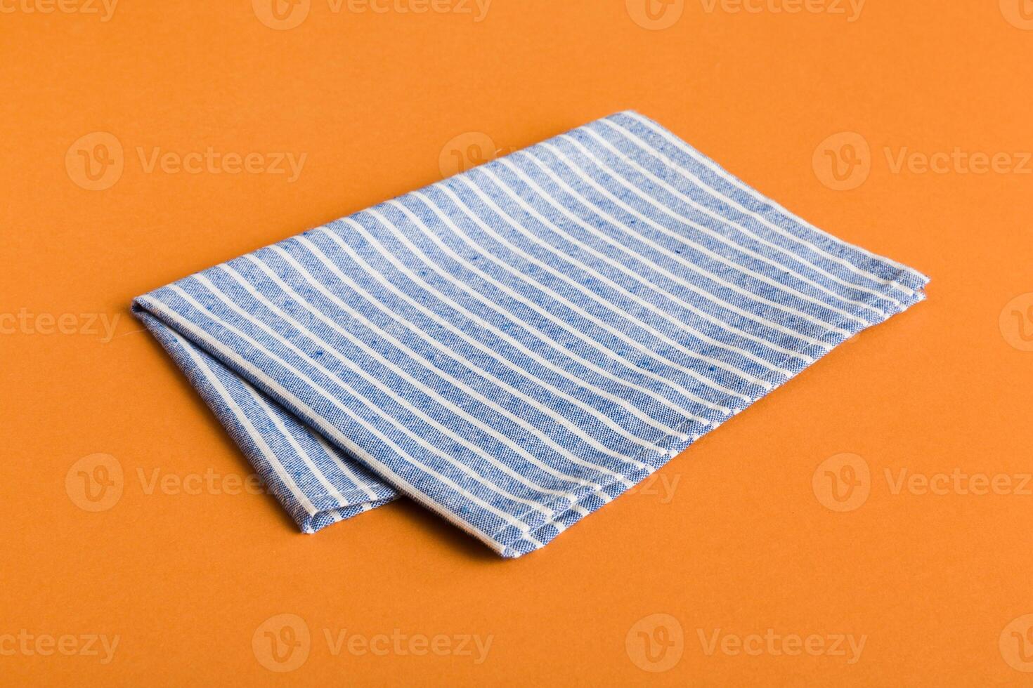top view with blue kitchen napkin isolated on table background. Folded cloth mockup photo