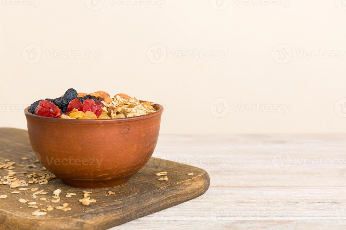 Cooking wholesome breakfast. Granola with Various dried fruits and nuts in a bowl. The concept of a healthy dessert photo